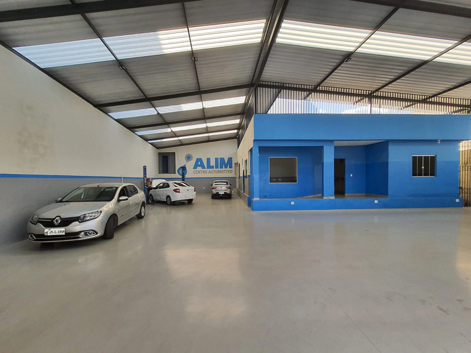 Oficina Mecânica Alim Betim - Centro Automotivo Completo - Mecânico Próximo a Mim com Estrutura Profissional Estrutura completa da oficina mecânica Alim em Betim - Centro automotivo com mecânicos perto de mim, fachada azul e área de atendimento para manutenção automotiva